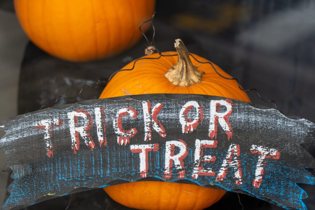 Halloween trick or treat banner on a pumpkin