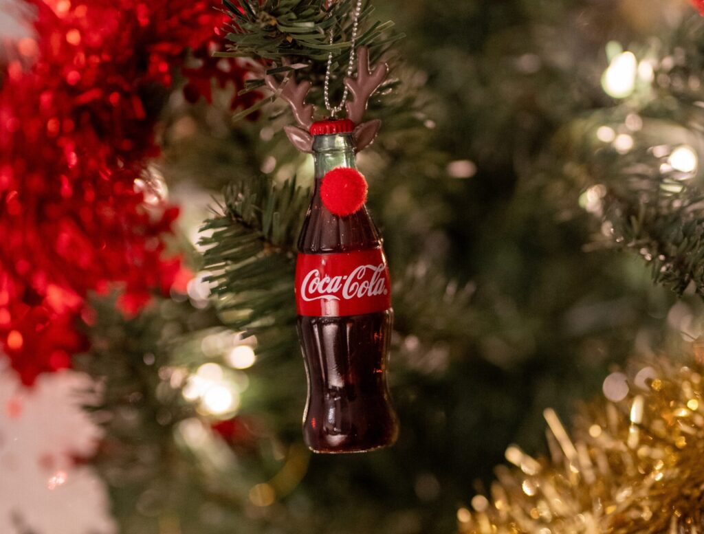 Coca Cola Christmas ornament hanging from a tree