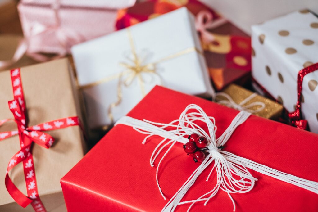 Christmas presents wrapped in red wrapping paper with ribbon