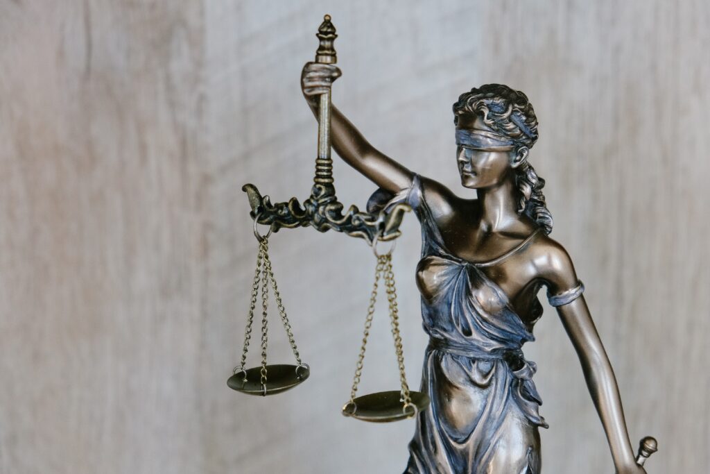 Statues of a woman holding balancing scales, weighing up her options