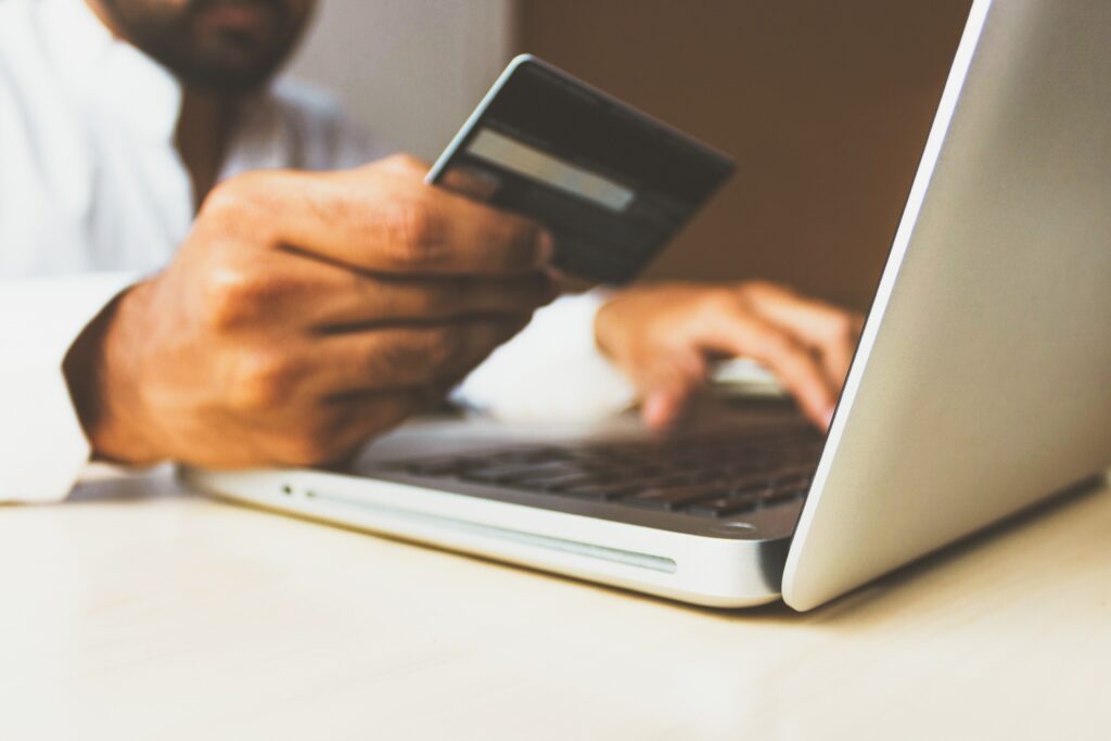 Man using credit card to complete a purchase online