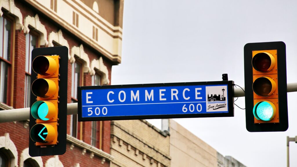 Street sign between traffic lights that reads 'eCommerce'