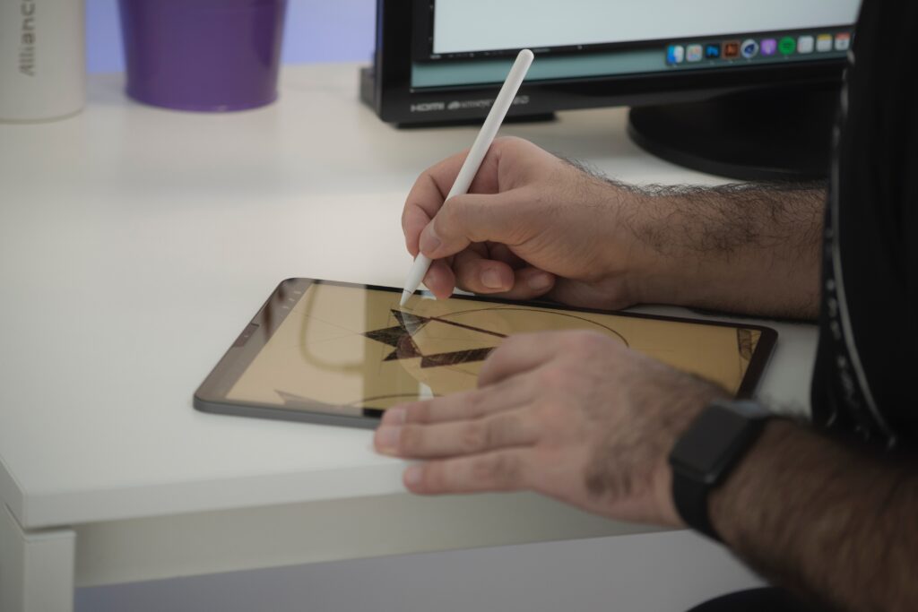 Man drawing a logo on an ipad as part of a brand identity