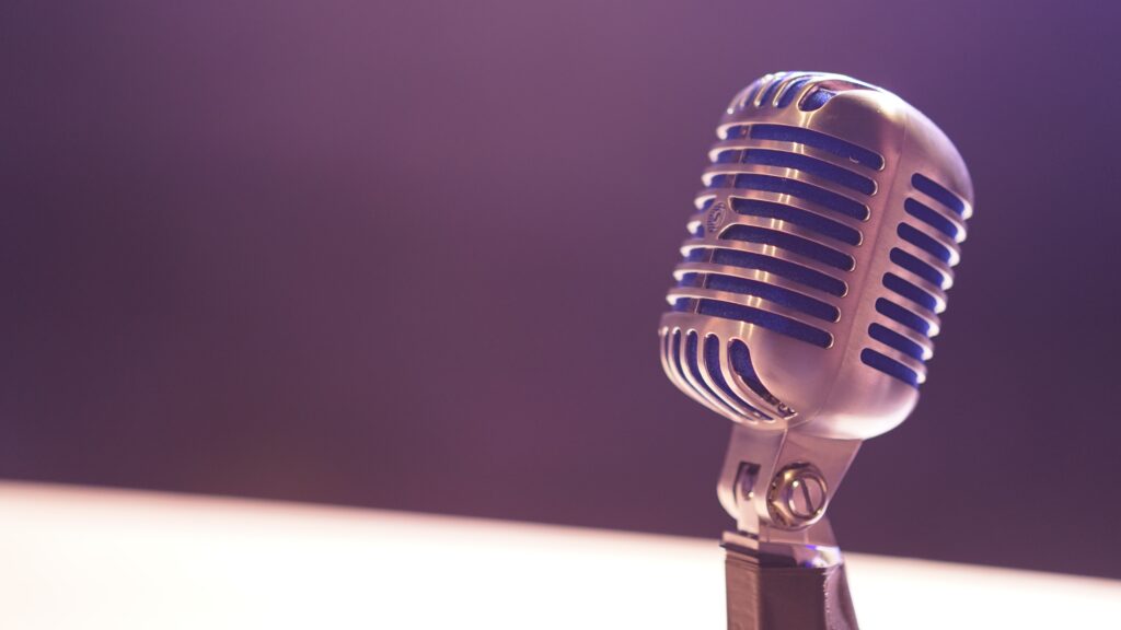 Old fashioned microphone against a purple background