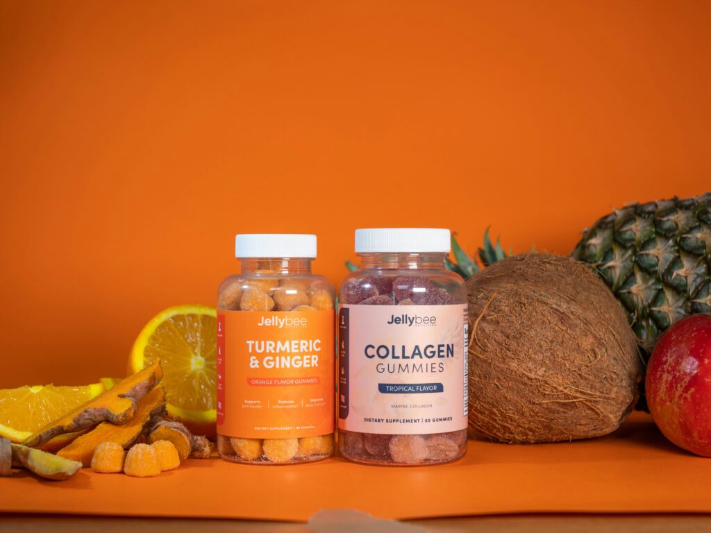 Turmeric and collagen health supplement bottles and tropical fruit