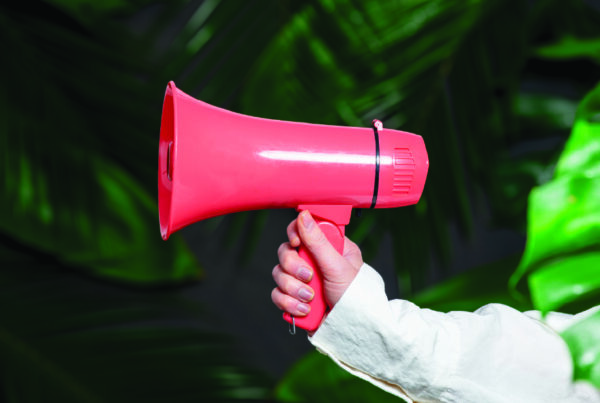 eCommerce Marketing Tips to Acquire, Convert and Retain Customers - Blog Header Image showing a man holding a megaphone