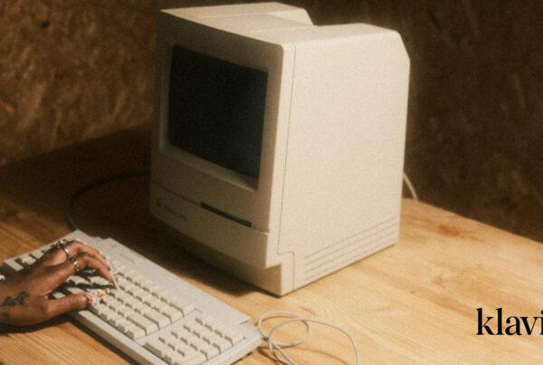 Which Email Marketing Flows are Important for eCommerce? Blog Header Image showing a computer on a desk and the Klaviyo logo in the bottom right corner