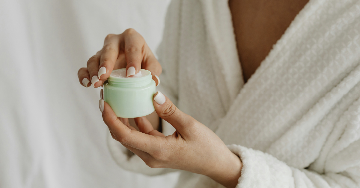Lifestyle imagery of a woman opening some face cream