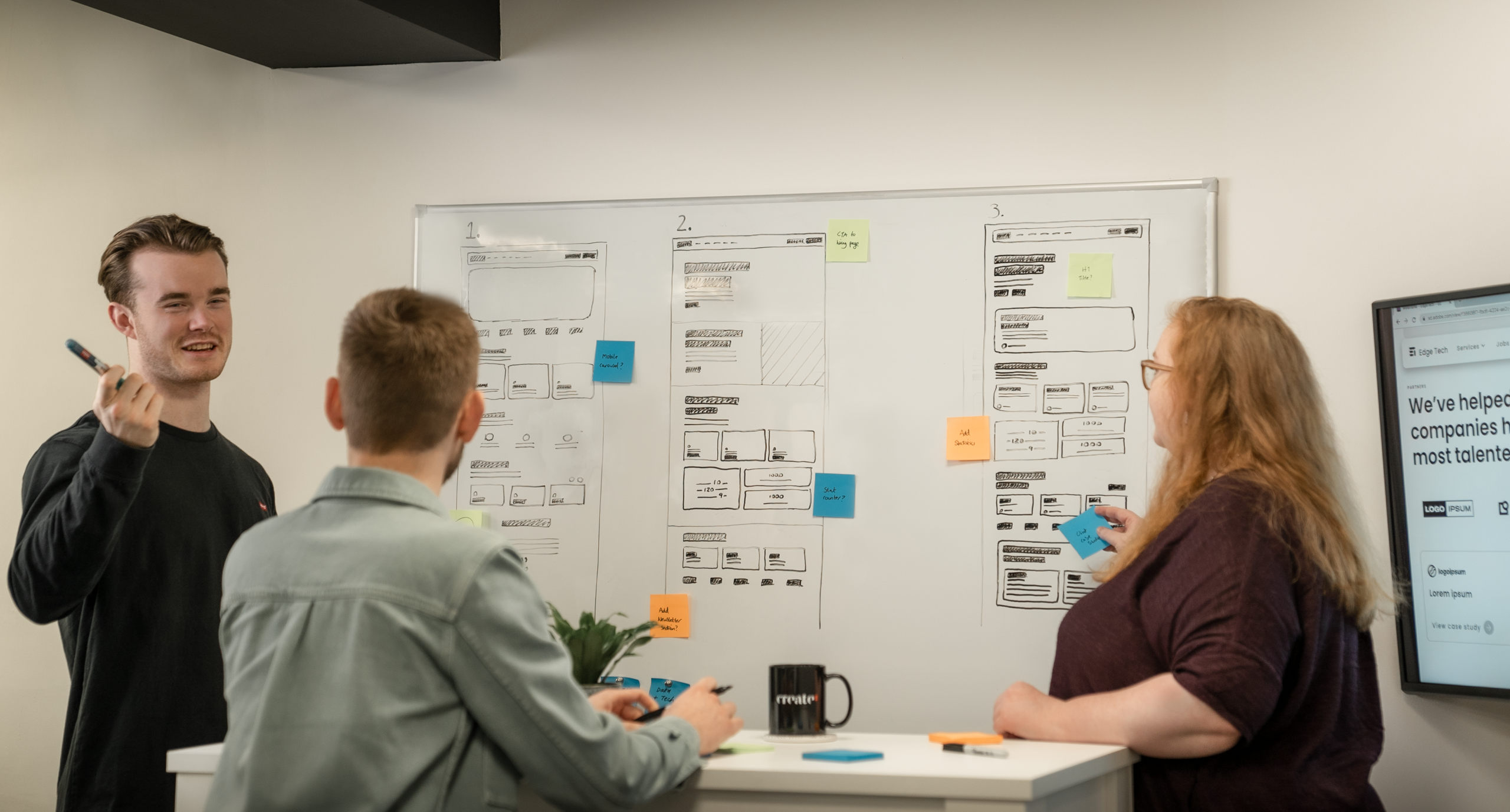 Create8 web developers and Shopify experts discussing a website wireframe
