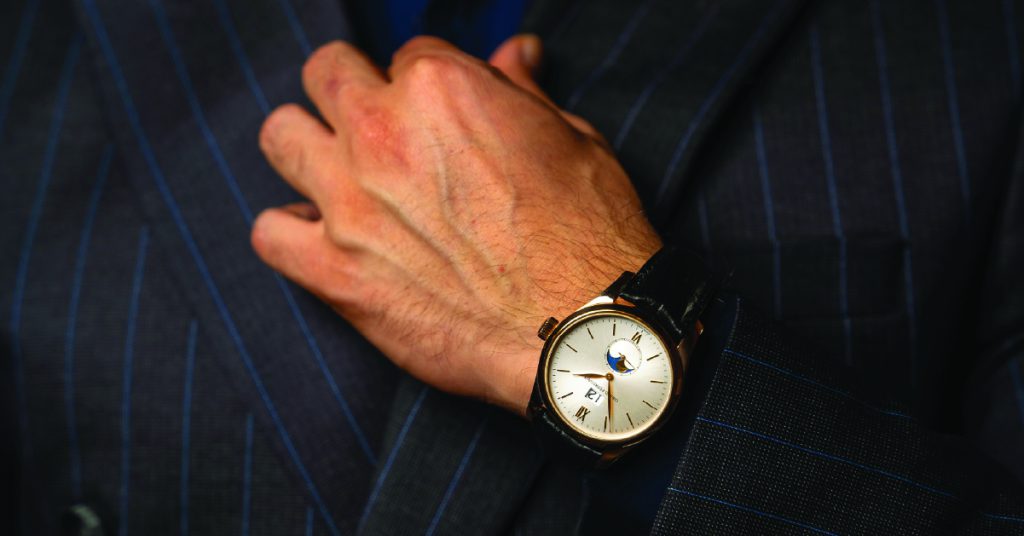 close up shot of a hand showing a man's watch