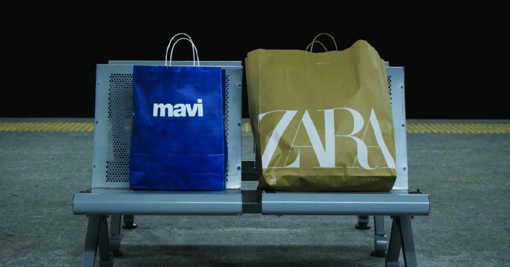Shopping bags on a train station bench