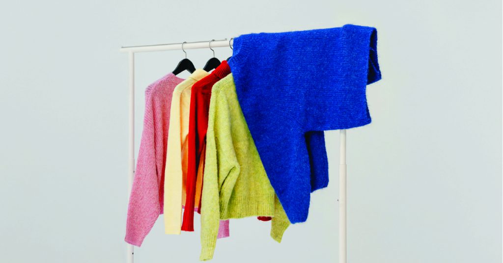 A rack of knitted jumpers in different colours