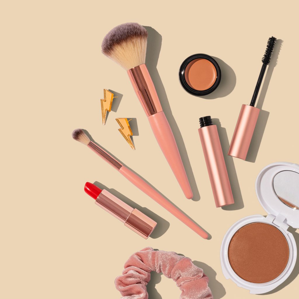 Selection of beauty products against a peach background