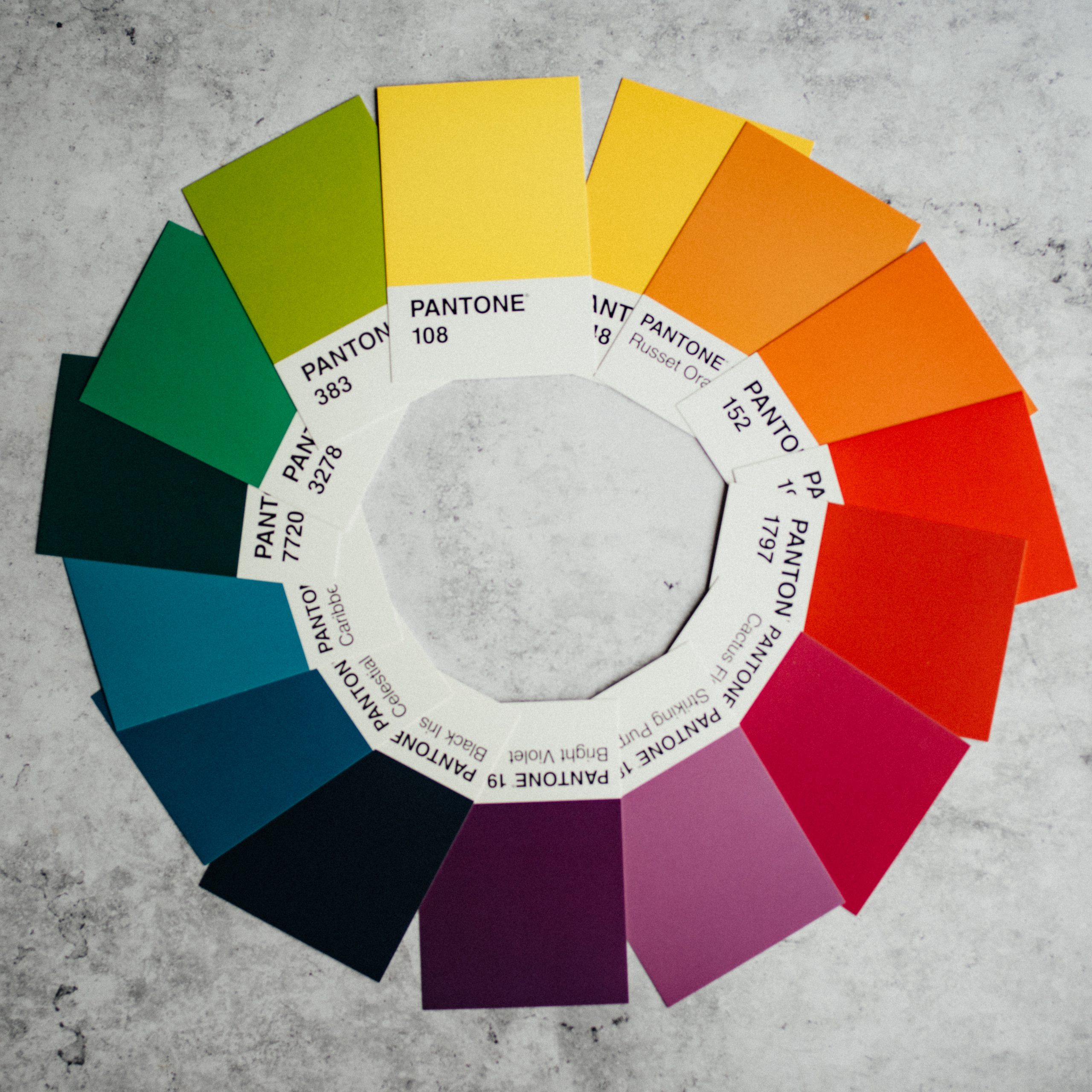Various Pantone swatches laid out in a colour wheel 