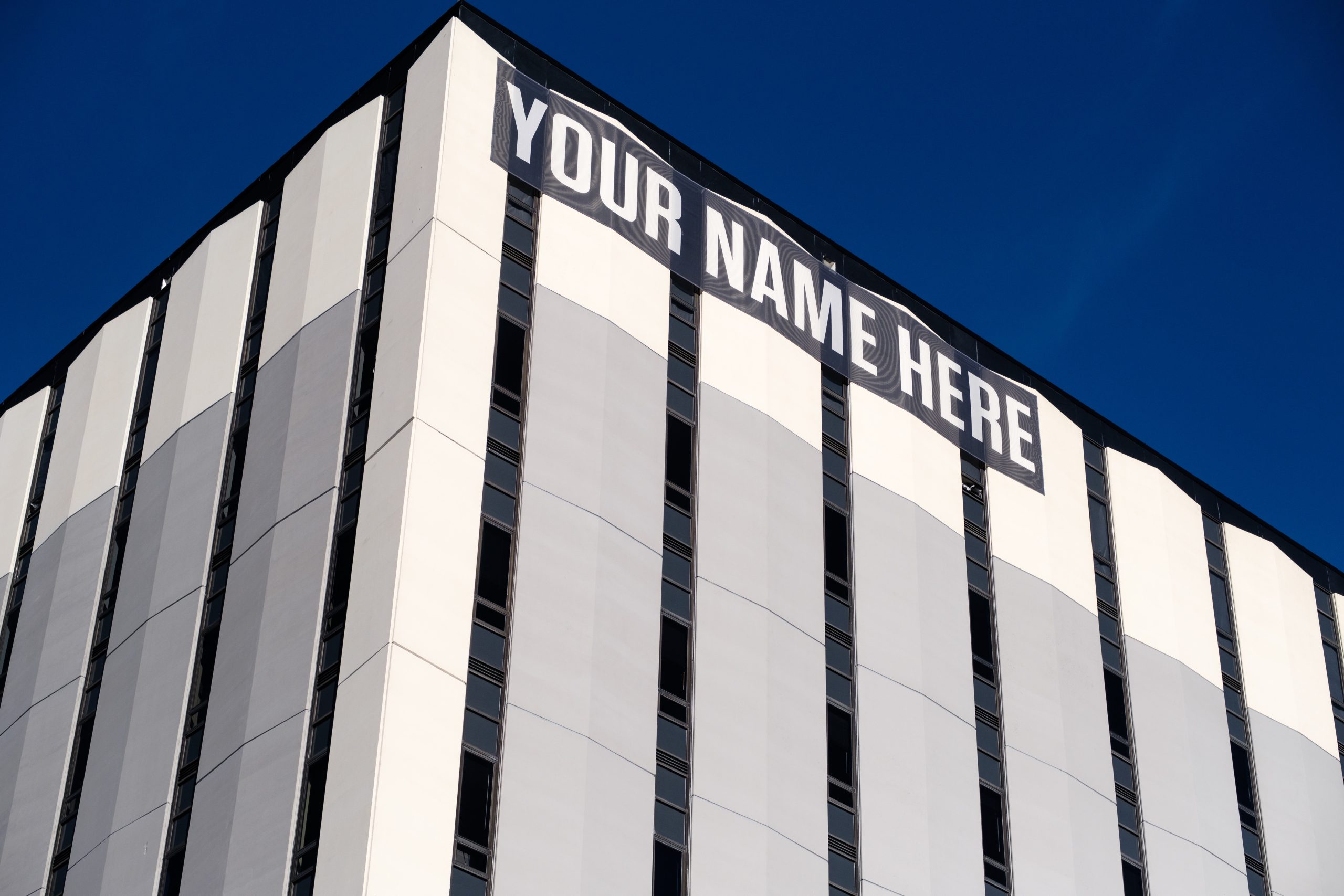 Building with a "Your Name Here" sign