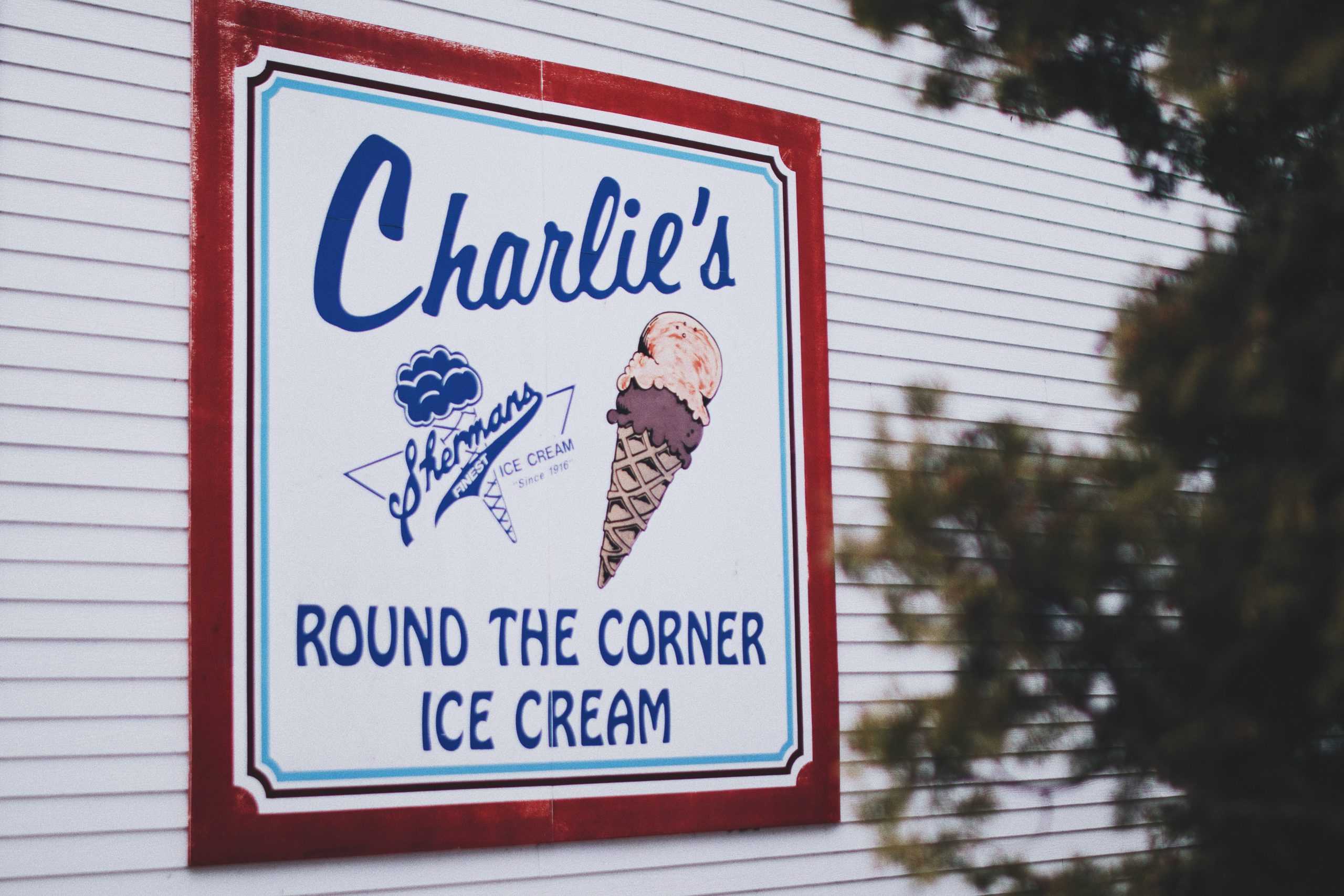 A Sign for Charlie's Ice Cream Parlour with a distinct Brand Voice which says "Round the corner ice cream"