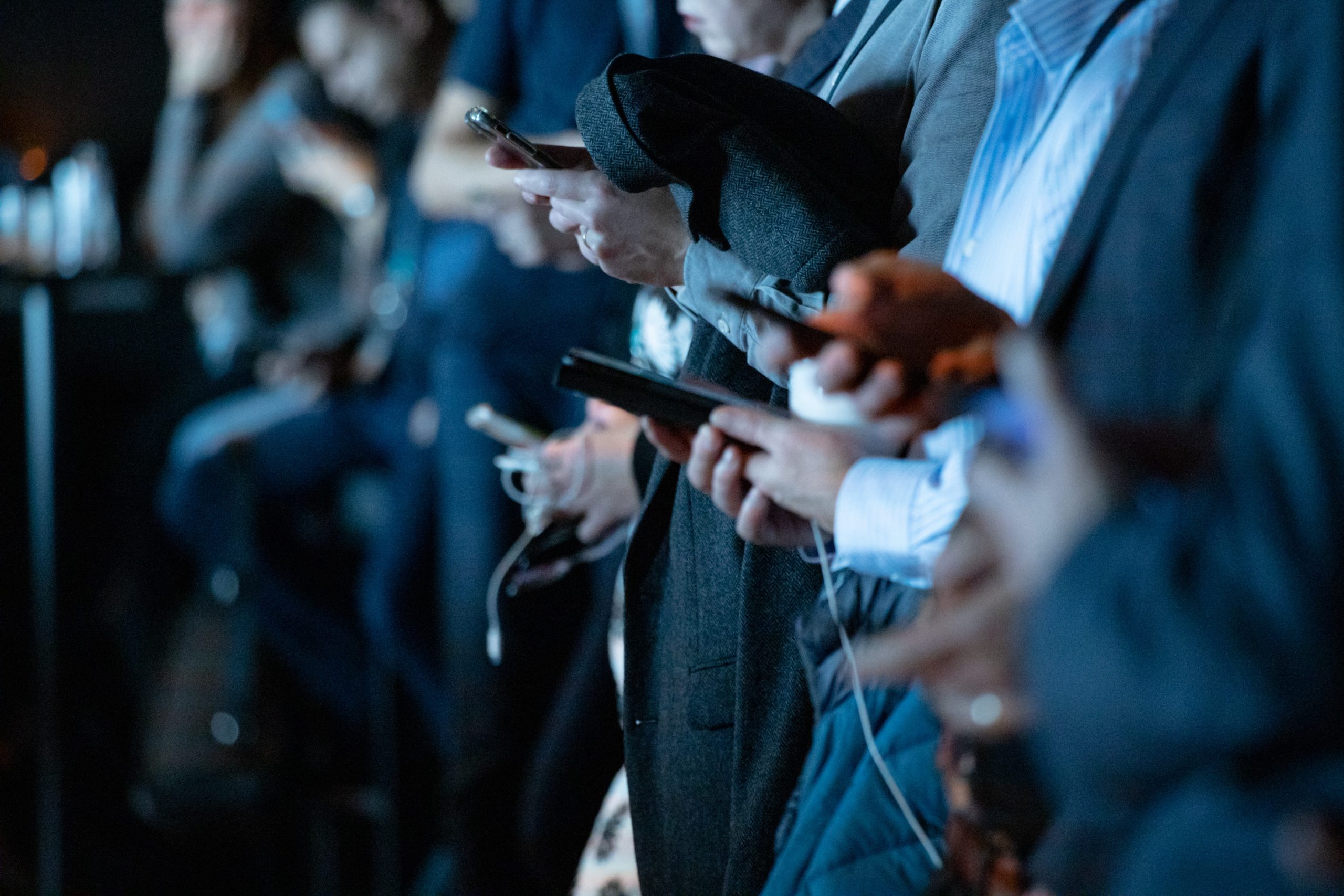 Group of Gen Z people on their mobile phones