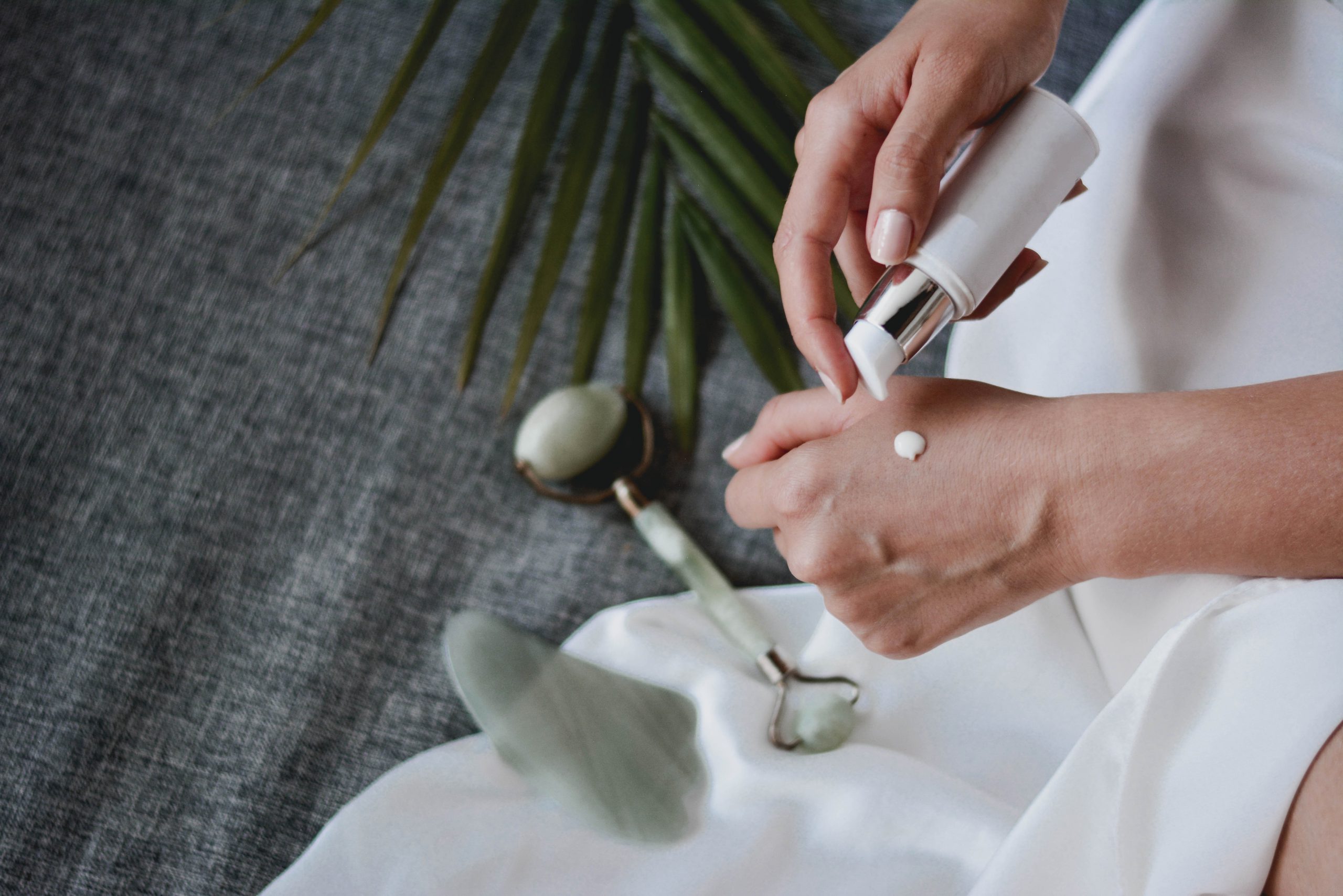 Women pumping face cream beauty product onto her hand 