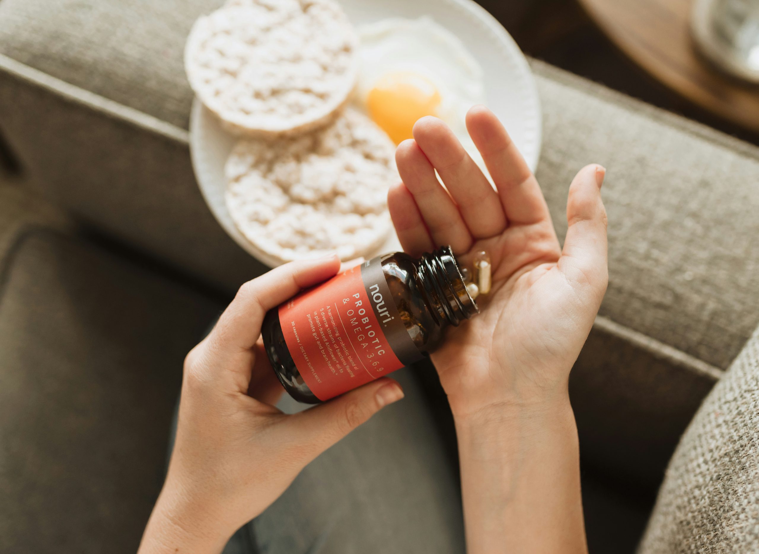 Person taking probiotic health supplements