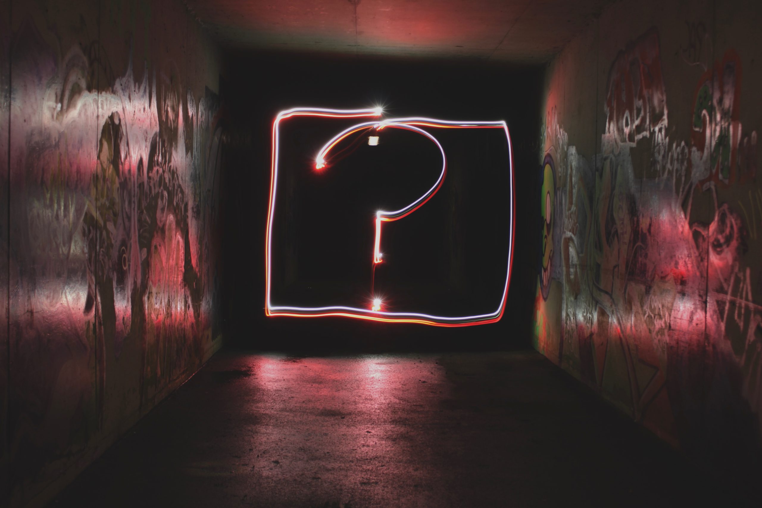 Neon question mark against a dark background – which product will they choose?
