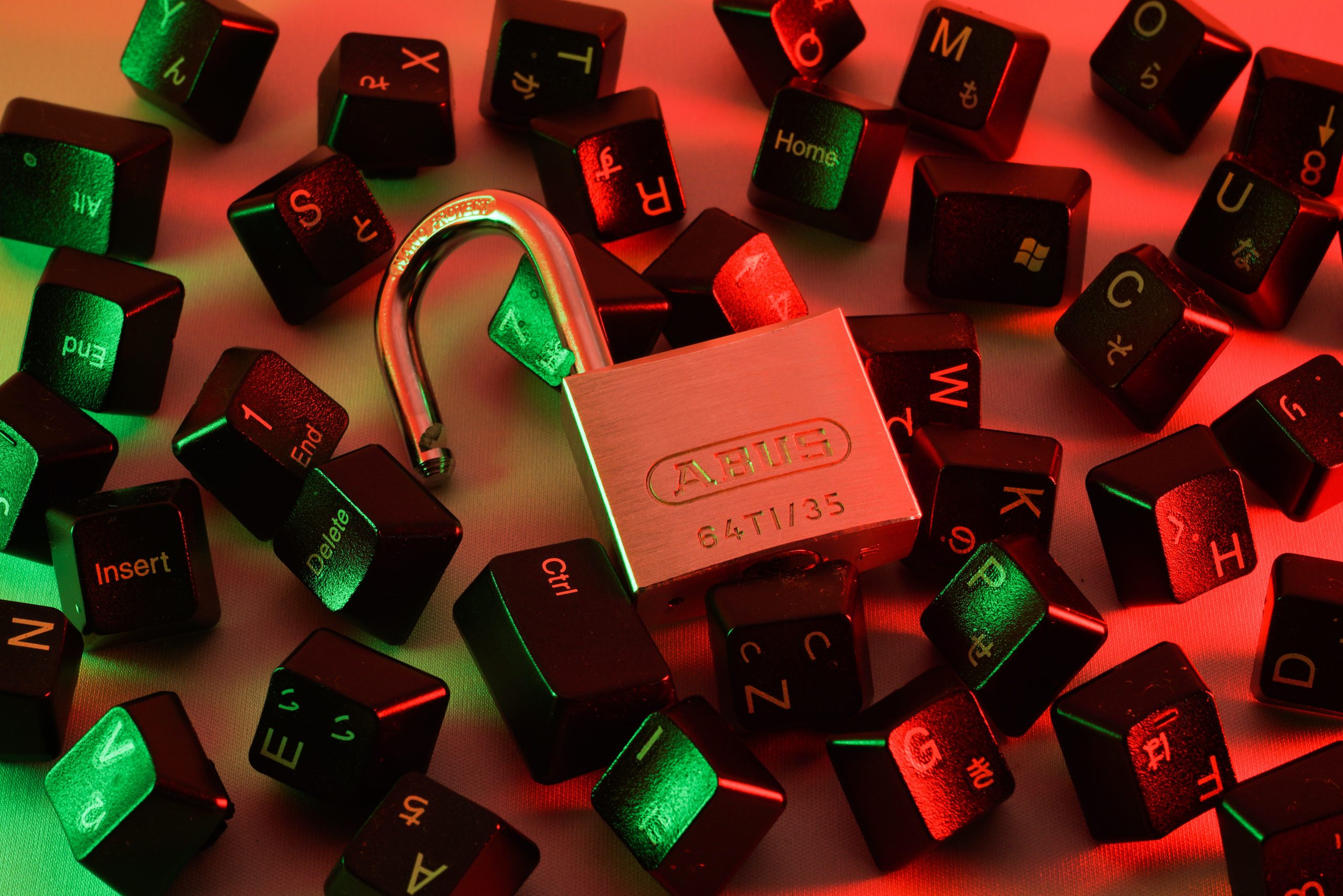 loose keyboard keys and an open padlock to represent eCommerce web security on Shopify or WooCommerce
