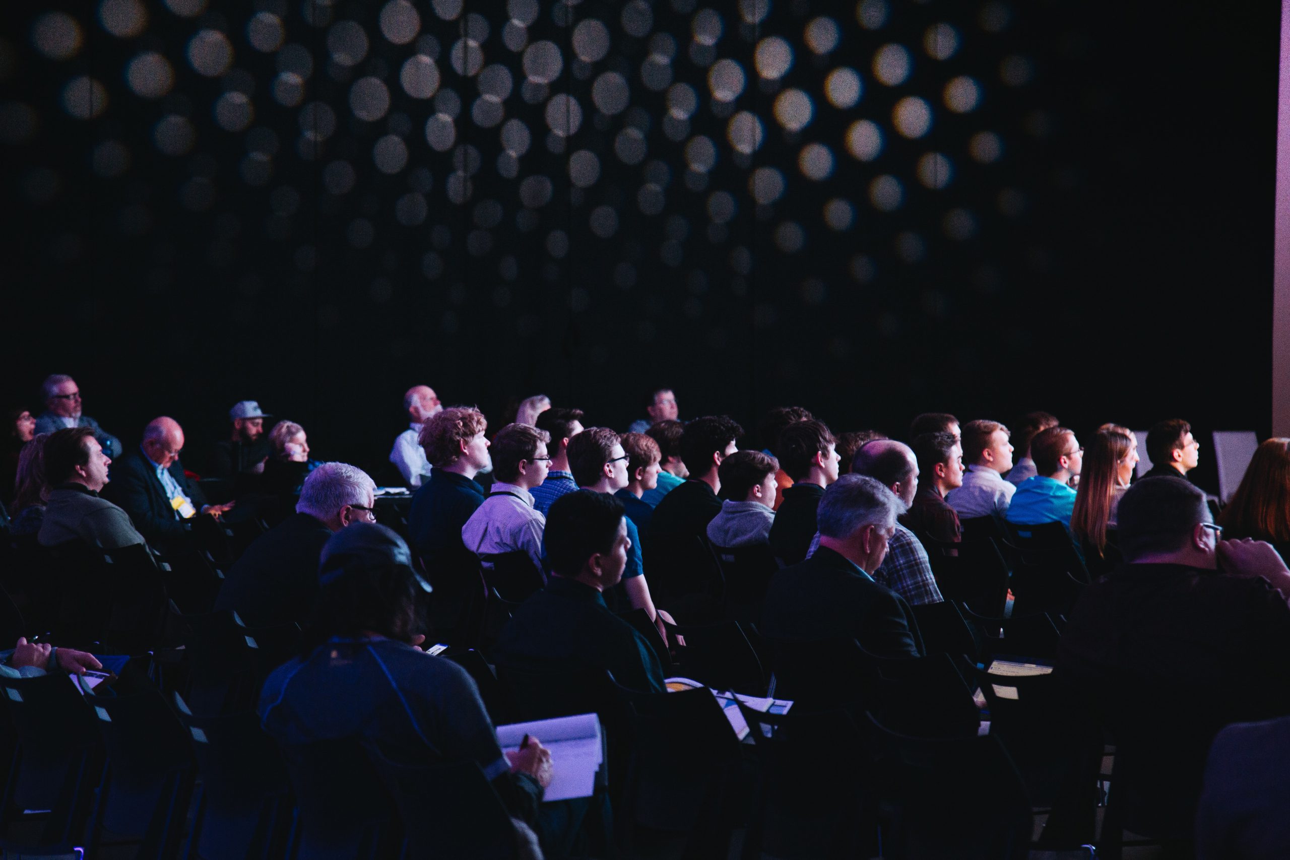 audience sat in a dark audiene listening intently to represent target audience