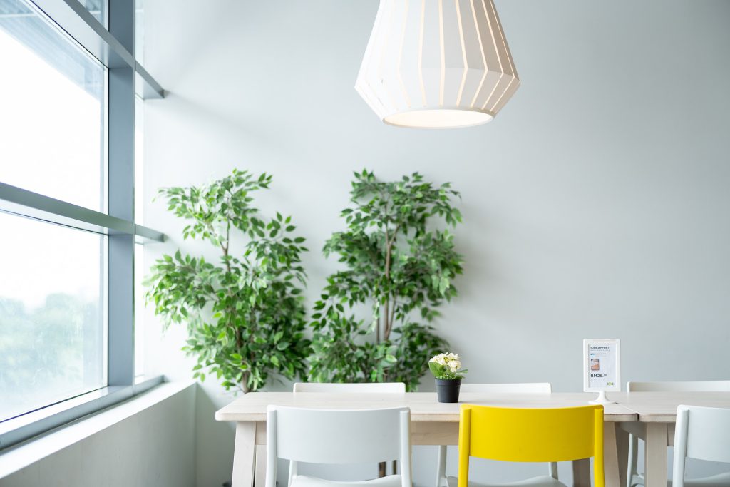 Scandinavian style desk with lamp, plant and chairs