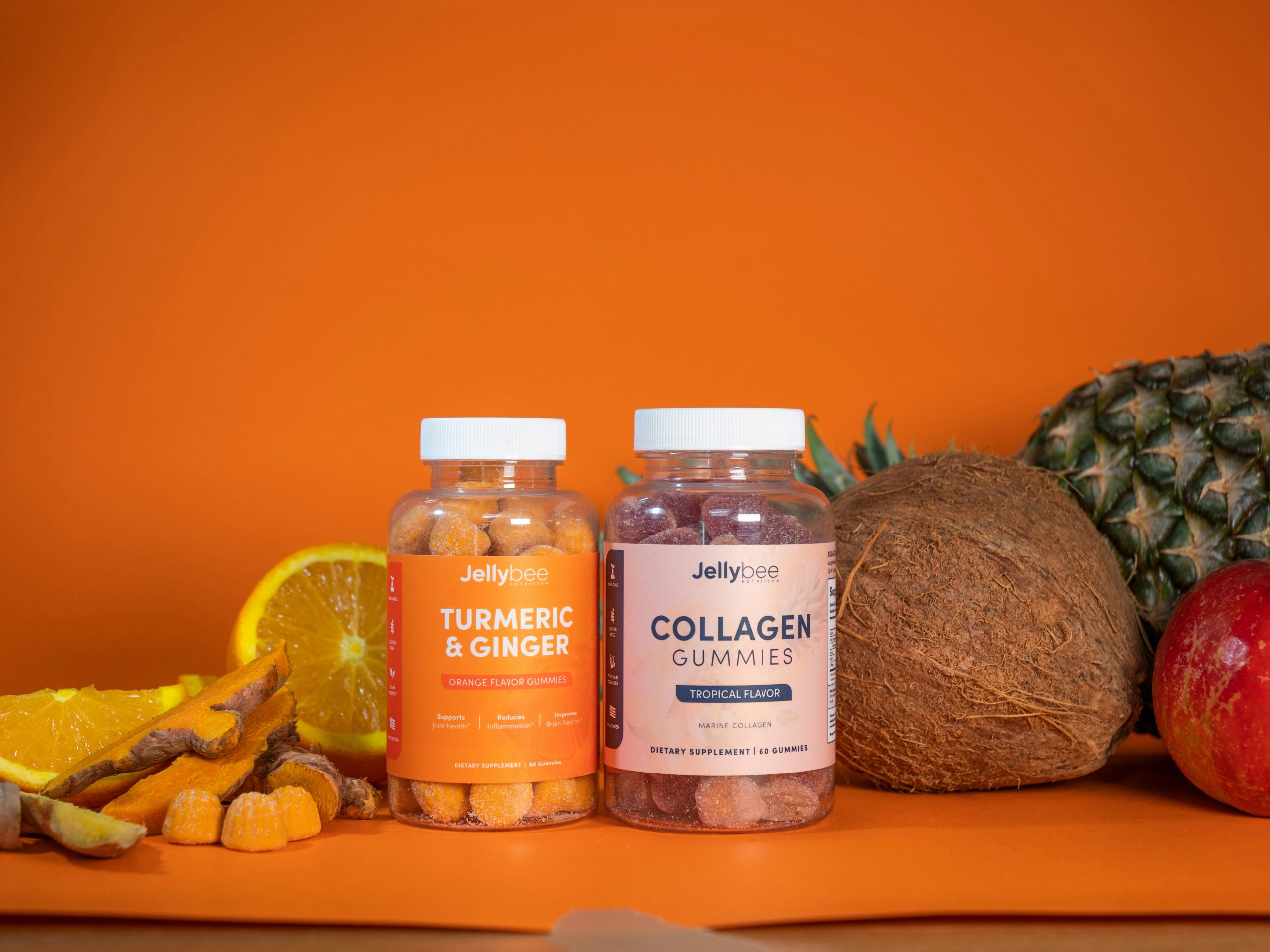 Turmeric and collagen health supplement bottles and tropical fruit