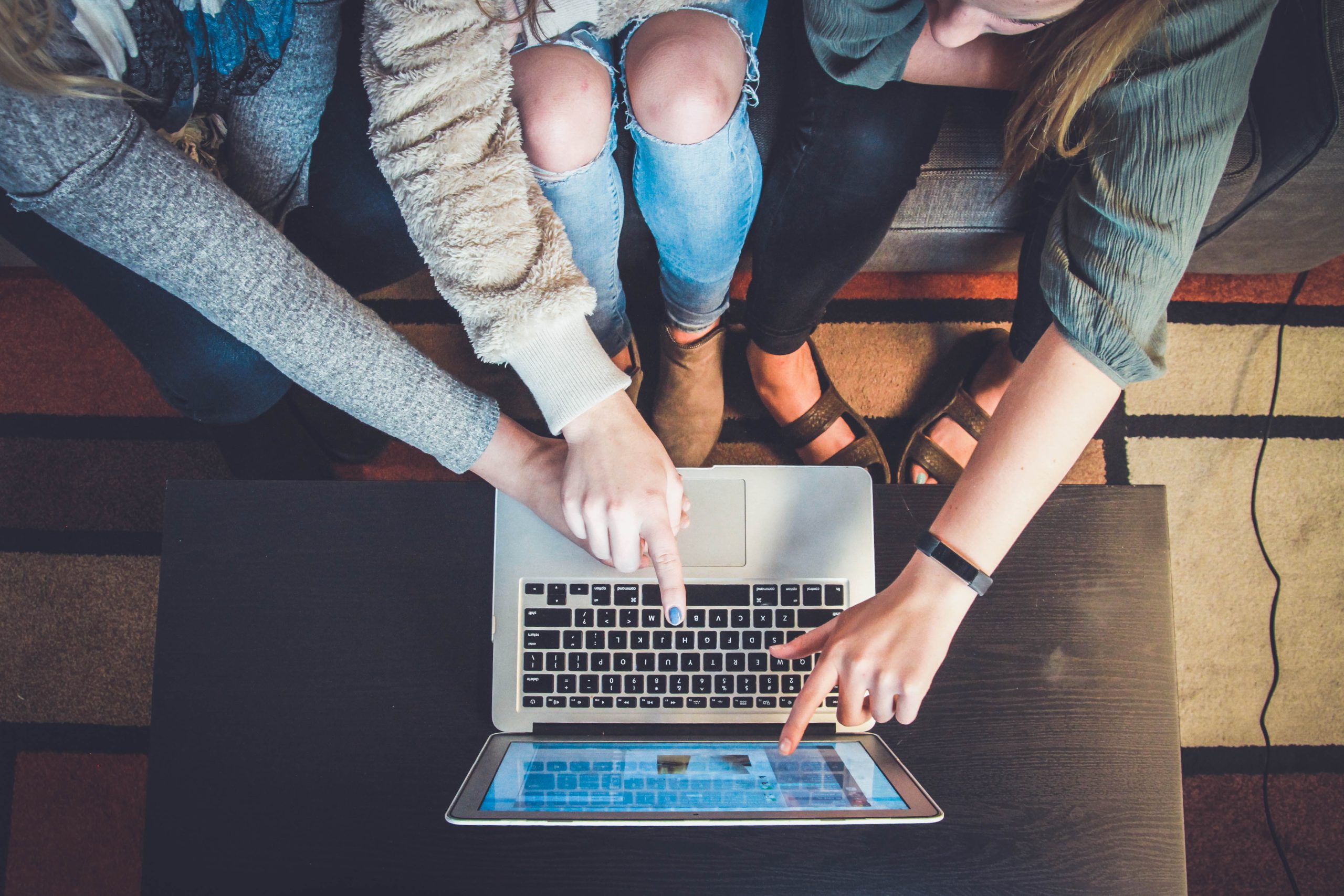 Group gathered around a laptop screen filling out a product recommendation quiz on a Shopify store