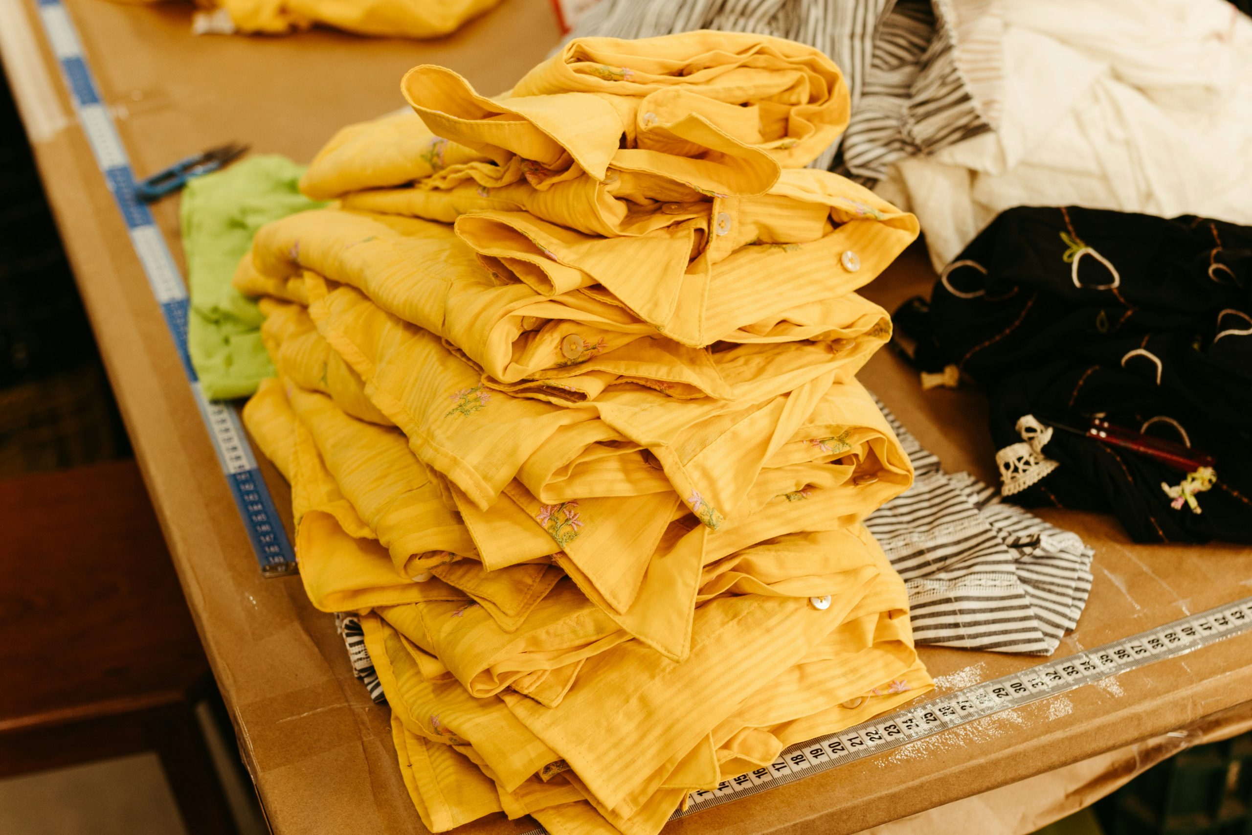 Yellow shirts stacked on a table