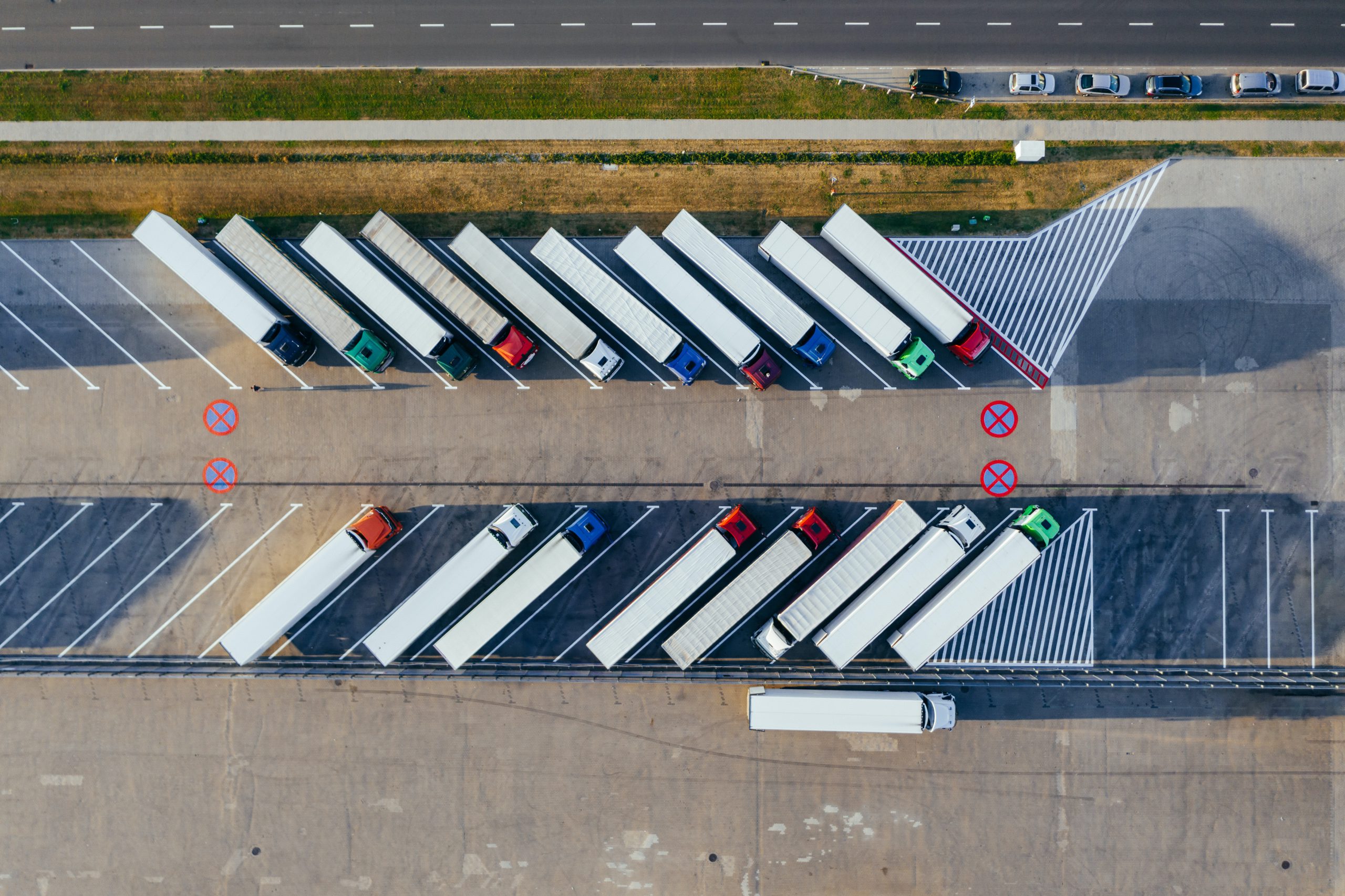 aerial view of lorries waiting in a carpark