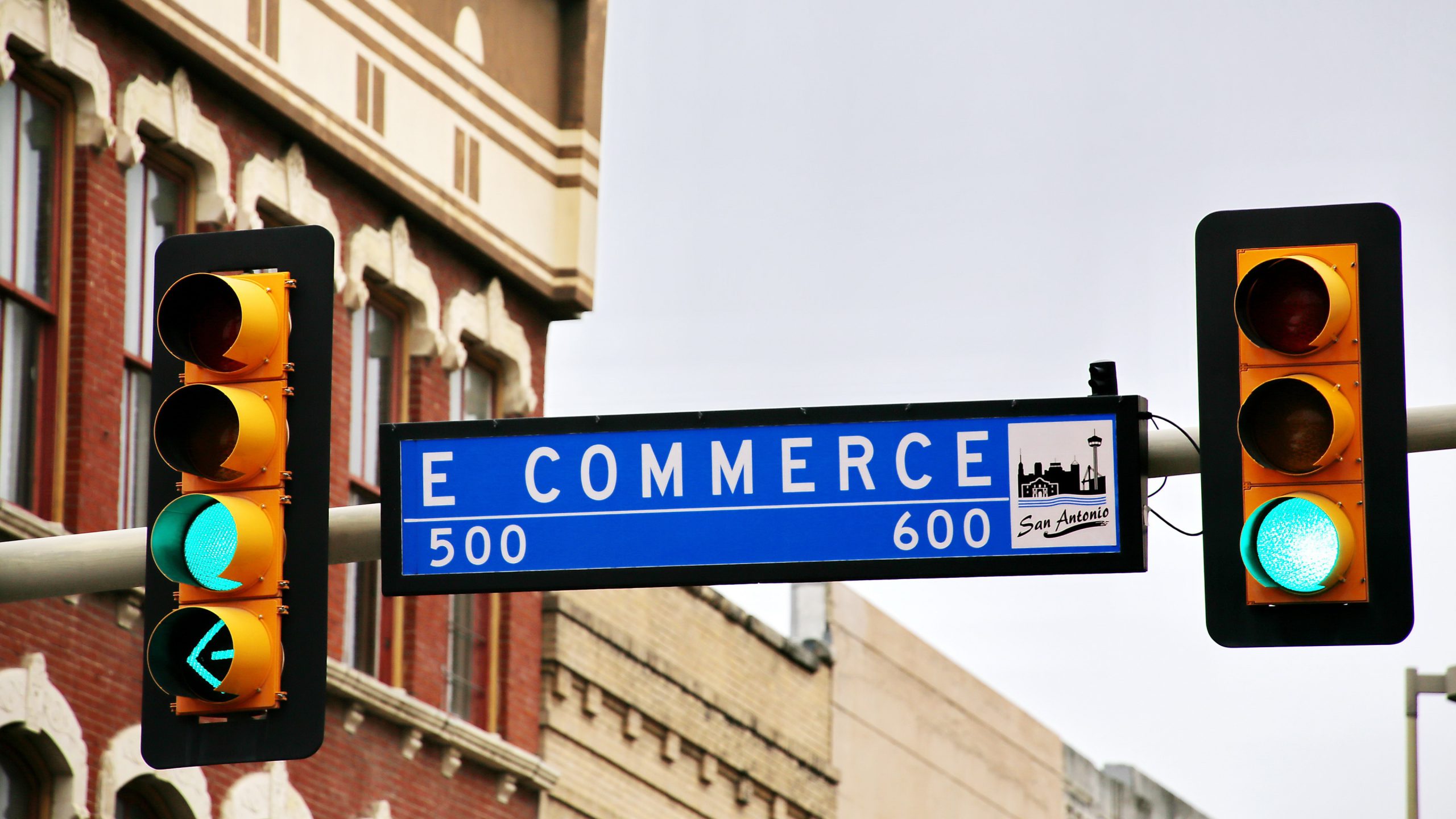 Street sign between traffic lights that reads 'eCommerce'