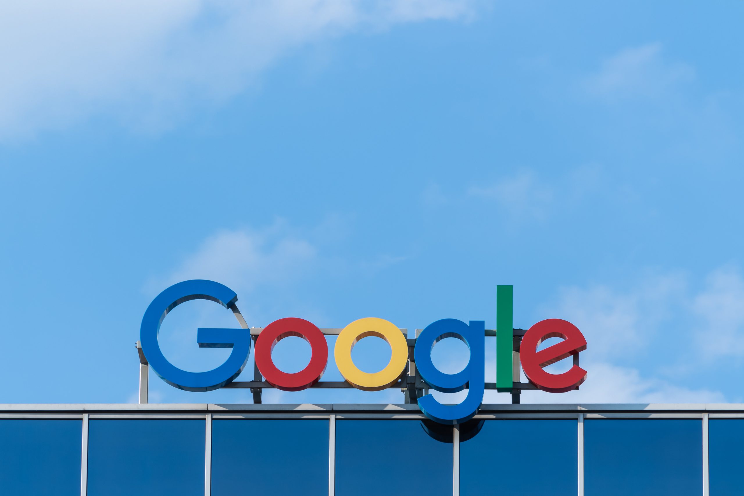Google signed displayed on a building against a blue sky