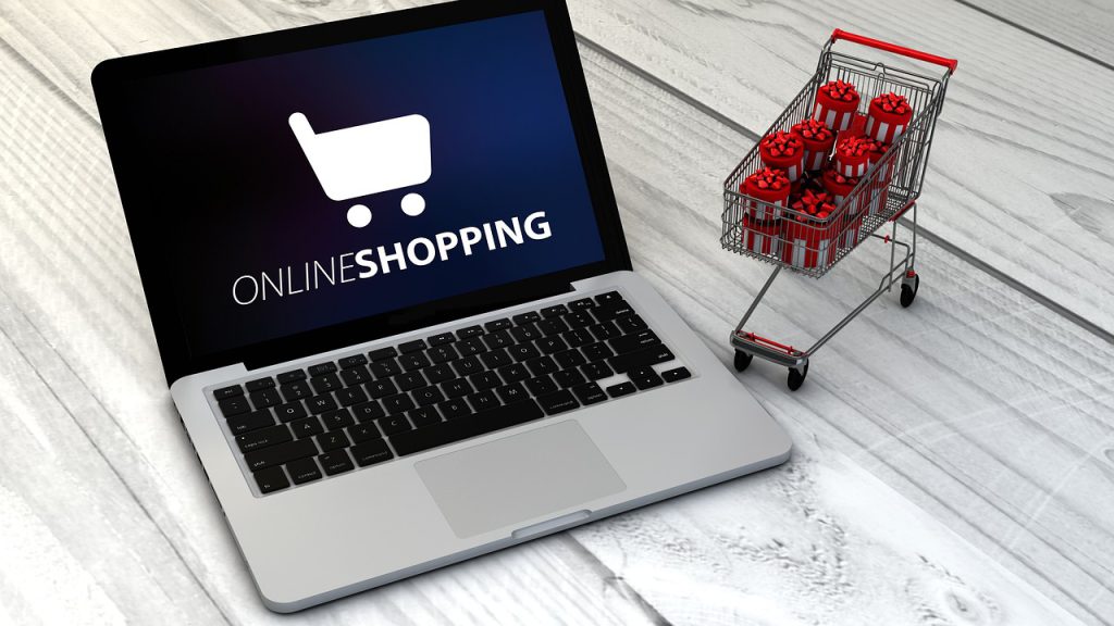 laptop screen showing 'online shopping' next to a small shopping trolley