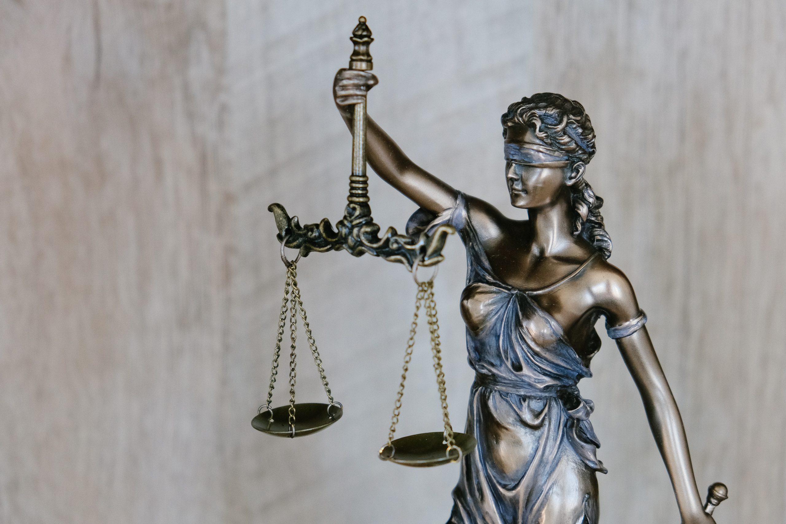 Statues of a woman holding balancing scales, weighing up her options