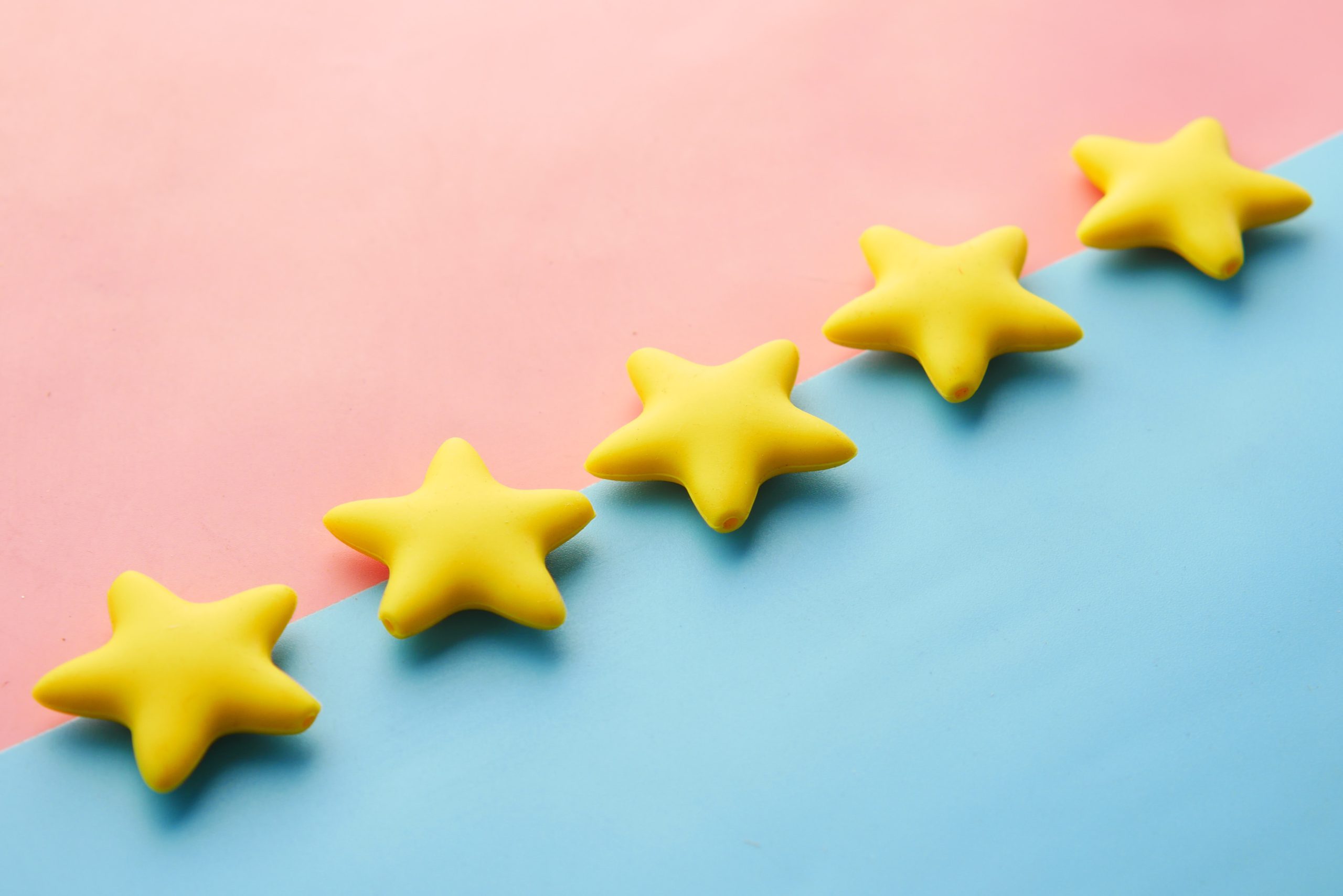 5 3D yellow stars against a pink and blue background